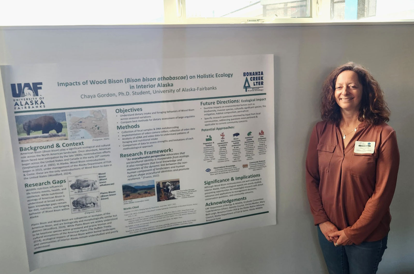 A graduate student explains her research on wood bison ecology at a conference.